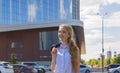 Woman freelancer enjoys summer walking on street