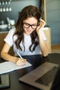 Woman freelancer hands with pen writing on notebook at home or office Royalty Free Stock Photo