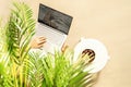 Woman freelancer with laptop sitting under coconut palm tree  branches. Female eating royal dates fruit from a bowl. Summer sand Royalty Free Stock Photo