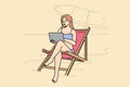 Woman freelancer working on beach, sitting in sun lounger with laptop on lap and enjoying comfort