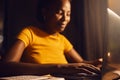 Woman freelancer working remote on a laptop while typing and answering emails online. Smiling, positive black female Royalty Free Stock Photo