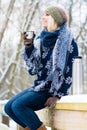 Woman freezing on a cold winter day warming herself up with hot drink Royalty Free Stock Photo