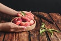 Woman with fresh donut peaches at wooden table, closeup Royalty Free Stock Photo