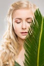 Woman and Fresh Exotic Palm Leaf, Face Hair Treatment, Young Model Beauty Portrait Natural Make Up