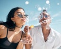 Woman, friends, and blowing bubbles by beach, ocean or sea on summer vacation, holiday travel or bonding activity. Women Royalty Free Stock Photo