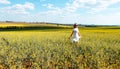 Woman frolicking in a field of flowers in spring