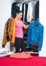 Woman in front of closet full of clothes Royalty Free Stock Photo