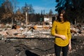 Woman in front of her burned home after fire disaster Royalty Free Stock Photo