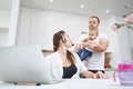 Mother sending air kiss to baby while busy at work