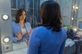 Woman in front of a mirror in the dressing room Royalty Free Stock Photo