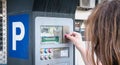 Woman in front of a parking ticket machine paying her parking in Albufeira, Portugal Royalty Free Stock Photo