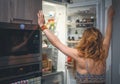 woman in front of the refrigerator. Royalty Free Stock Photo