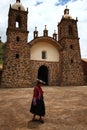 Woman in front of a rural stone Church