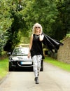 Woman in front of a sports car