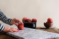 Woman in front of the table with red apple in hand Royalty Free Stock Photo