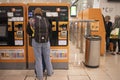 Woman in front of the ticket vending machine at Sants station, Barcelona Royalty Free Stock Photo