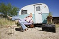 Woman in front of Travel Trailer Royalty Free Stock Photo