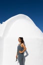 Woman in Front of White Building in Santorini, Greece