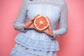 Woman fruit diet and healthy food eating concept. Girl holds grapefruit in hands.