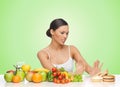 Woman with fruits rejecting hamburger Royalty Free Stock Photo
