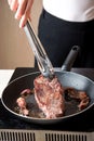 Woman frying beef steak frying at home Royalty Free Stock Photo