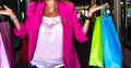 woman with fuchsia jacket with colored envelopes in her hands. shopping and women