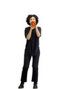 A woman, full-length, on a white background, with a megaphone Royalty Free Stock Photo