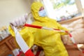 Woman in a full protective suit secures with a barrier tape Royalty Free Stock Photo