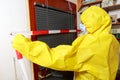 Woman in a full protective suit secures with a barrier tape Royalty Free Stock Photo