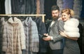 Woman in fur coat with man. Seller and customer. Date, couple, love, man and woman. Fur coat, luxury. Fashion and beauty