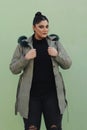 a woman in a fur hat with long green coat and black pants Royalty Free Stock Photo