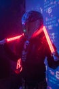 Woman in Futuristic Tactical Black Suit and Motorcycle Helmet with Neon Lamps