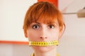 Woman gagged by a tape measure Royalty Free Stock Photo