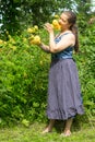 A woman in the garden admires her flowers.