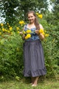 A woman in the garden admires her flowers.