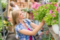 Woman at garden centre shopping for flowers Royalty Free Stock Photo