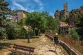 Woman in a garden with trees, houses and cliff in Chateaudouble