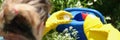 Woman gardener adding fertilizer for plants to watering can