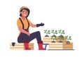 Woman gardener. Cute girl sitting near seedling boxes. Growing plants, hobby and leisure activity. Advertising of work