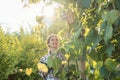 Woman in garden checking the grapevines