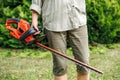 Woman gardener holding electric hedge trimmer Royalty Free Stock Photo