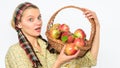 Woman gardener rustic style hold basket with apples white background. Eco friendly product concept. Woman sincere Royalty Free Stock Photo