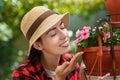 Woman gardener smelling flowers Royalty Free Stock Photo