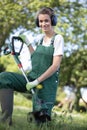 Woman gardener using string lawn trimmer Royalty Free Stock Photo