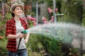 Woman gardener watering garden Royalty Free Stock Photo