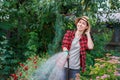 Woman gardener watering garden Royalty Free Stock Photo