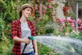 Woman gardener watering garden Royalty Free Stock Photo