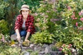 Woman gardener weeding weeds