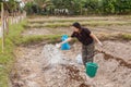 Woman gardeners put lime or calcium hydroxide into the soil to neutralize the acidity of the soil Royalty Free Stock Photo