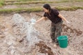 Woman gardeners put lime or calcium hydroxide into the soil to neutralize the acidity of the soil Royalty Free Stock Photo